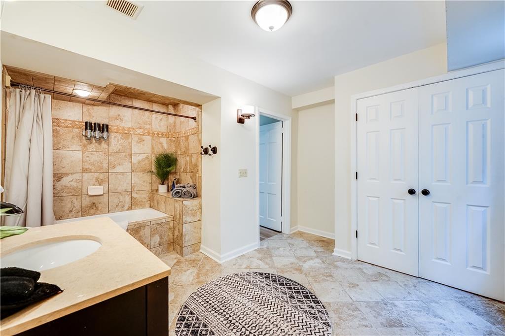 2083 West Rugby Avenue College Park, GA 30337 - Photo 43 of 49 a spacious bathroom with a tub shower and sink