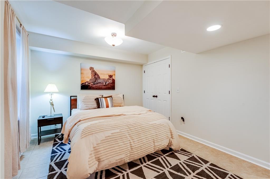 2083 West Rugby Avenue College Park, GA 30337 - Photo 45 of 49 a bedroom with a bed and a chandelier