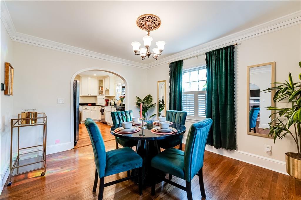 2083 West Rugby Avenue College Park, GA 30337 - Photo 9 of 49 a dining room with furniture a chandelier and wooden floor