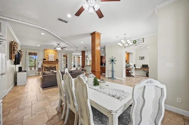 a view of a dining room and livingroom with furniture wooden floor a chandelier