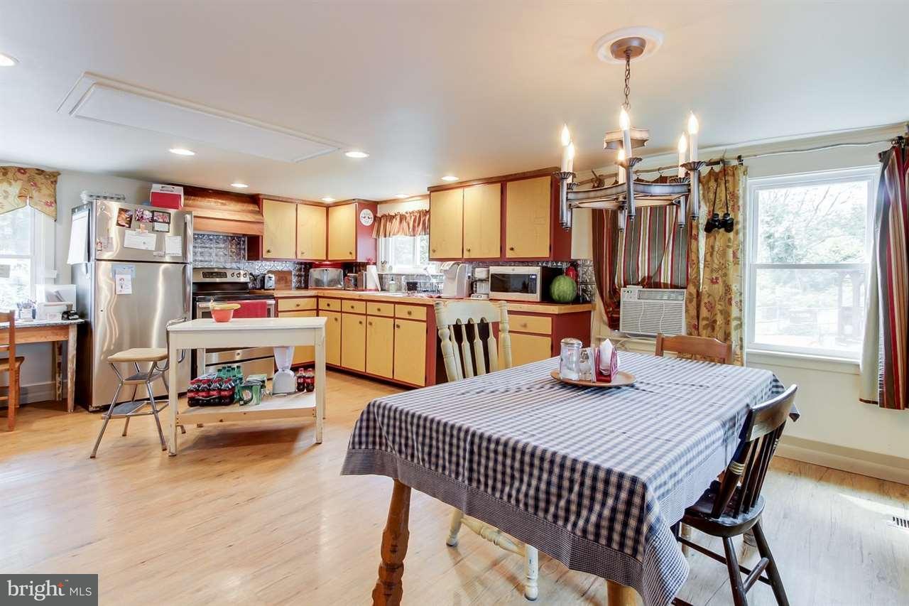 1745 Beck Mill Road Hanover, PA 17331 - Photo 11 of 25 a view of a dining room and livingroom with furniture wooden floor a chandelier