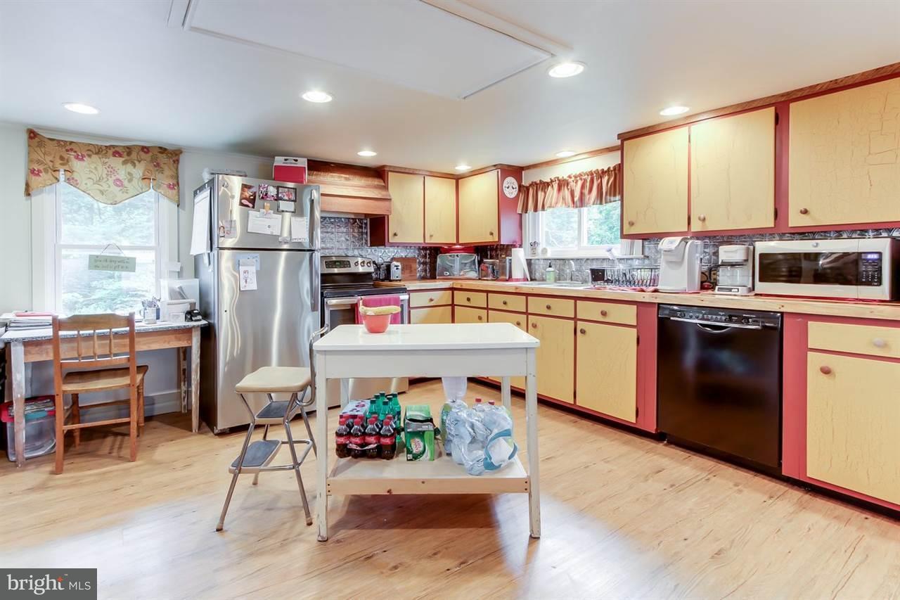 1745 Beck Mill Road Hanover, PA 17331 - Photo 10 of 25 a kitchen with stainless steel appliances granite countertop a stove top oven a sink dishwasher and white cabinets with wooden floor