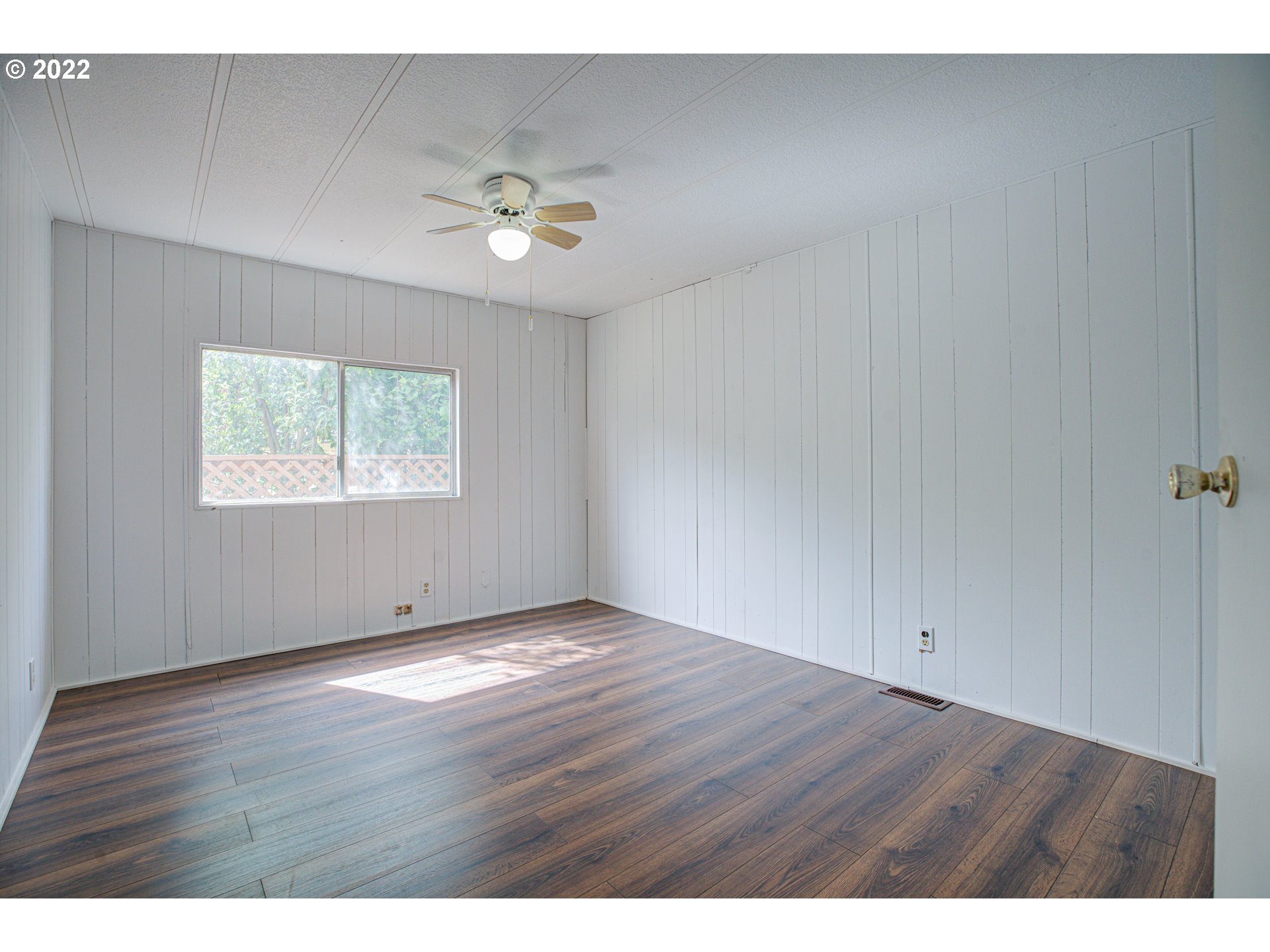 9290 Southwest Link Street Cornelius, OR 97113 - Photo 11 of 18 a view of an empty room with wooden floor and a window