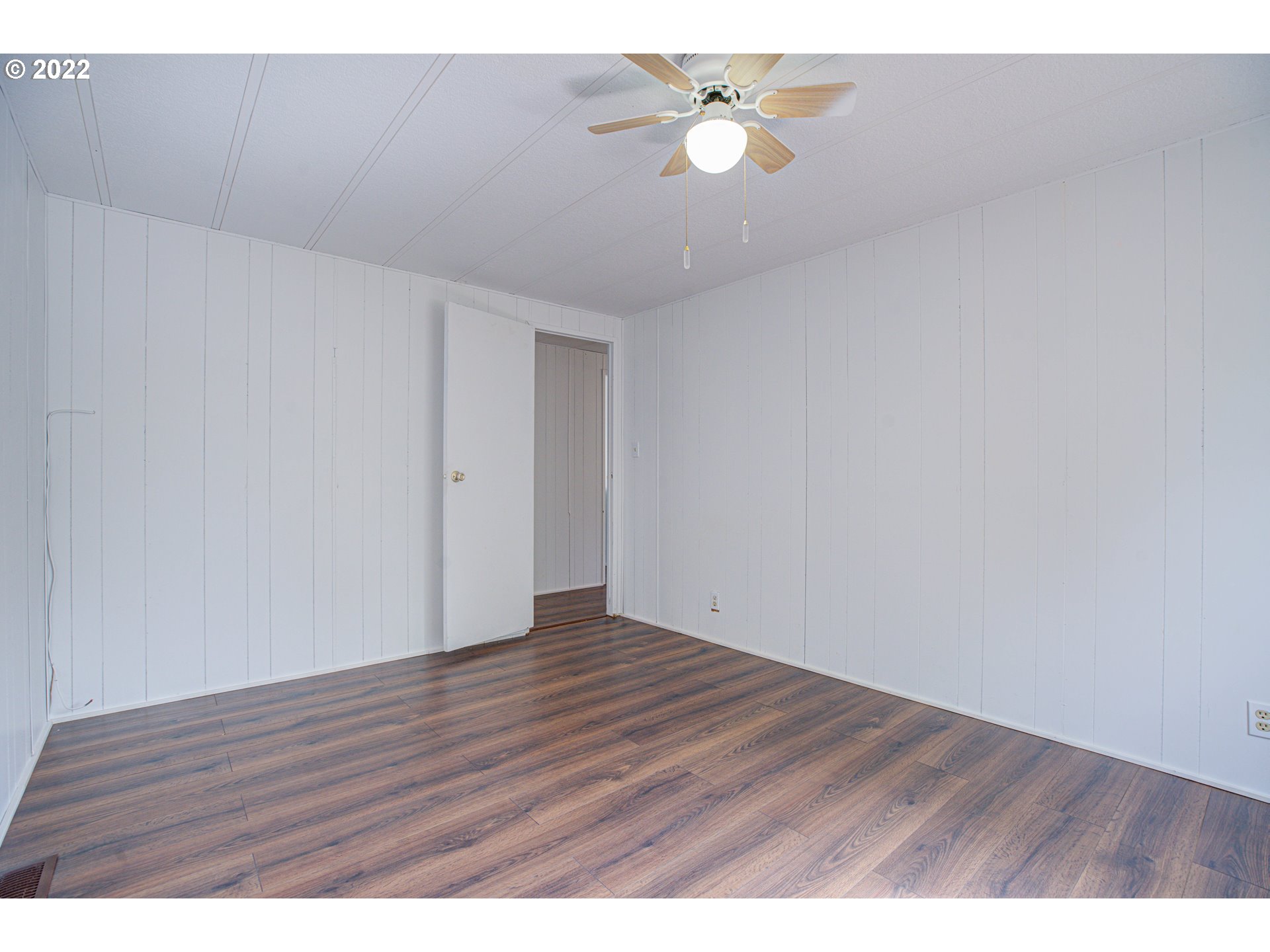 9290 Southwest Link Street Cornelius, OR 97113 - Photo 12 of 18 a view of an empty room with wooden floor