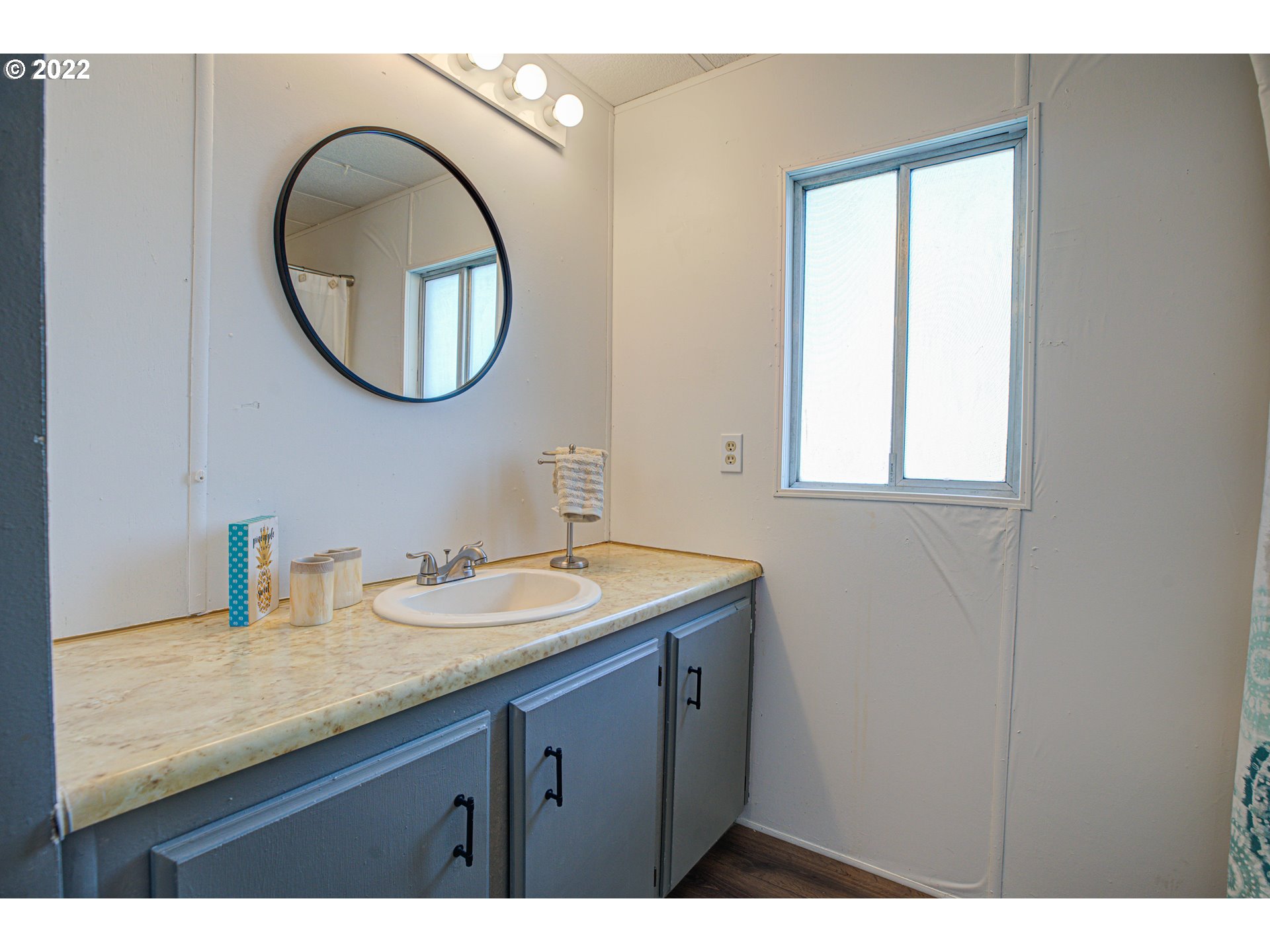 9290 Southwest Link Street Cornelius, OR 97113 - Photo 13 of 18 a bathroom with a granite countertop sink a mirror and a window