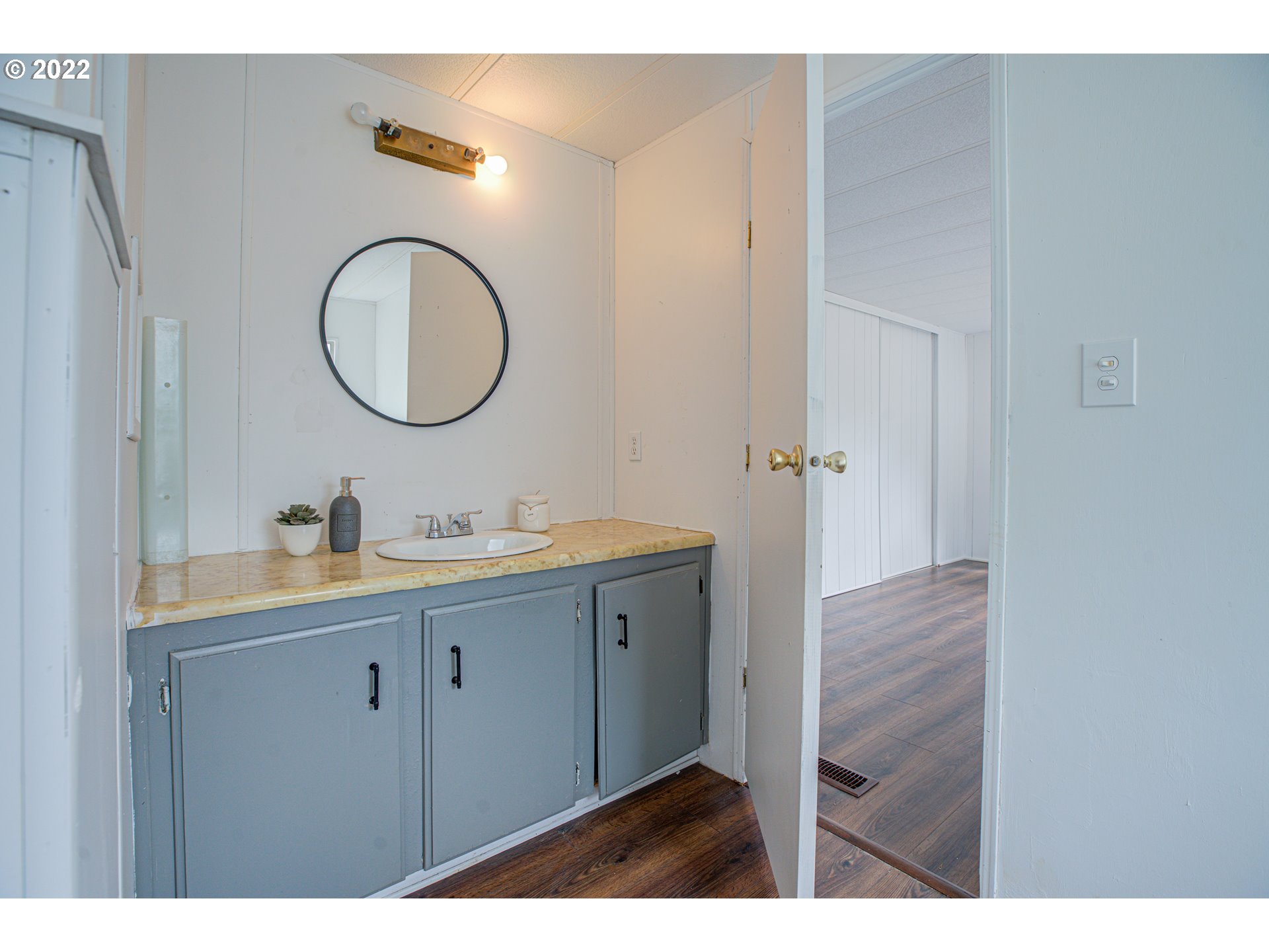 9290 Southwest Link Street Cornelius, OR 97113 - Photo 16 of 18 a bathroom with a granite countertop sink a mirror and a