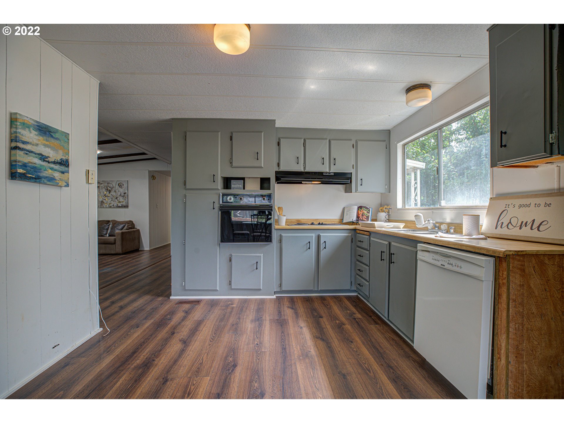 9290 Southwest Link Street Cornelius, OR 97113 - Photo 6 of 18 a kitchen with cabinets wooden floor and stainless steel appliances