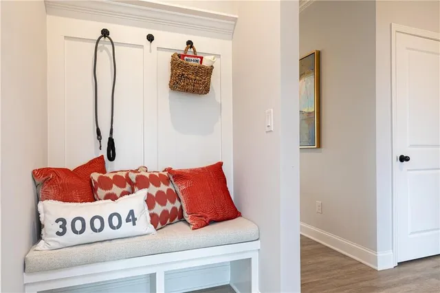 a living room with couch and a table with chairs