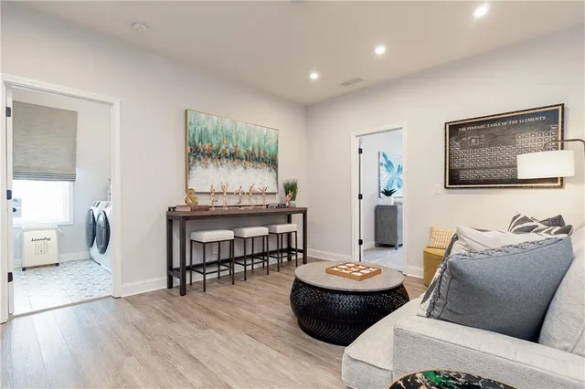a spacious bedroom with a bed couch and window