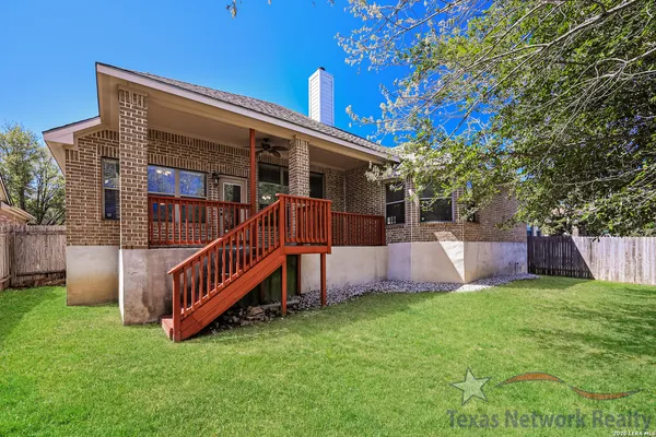 a view of a house with a yard and deck