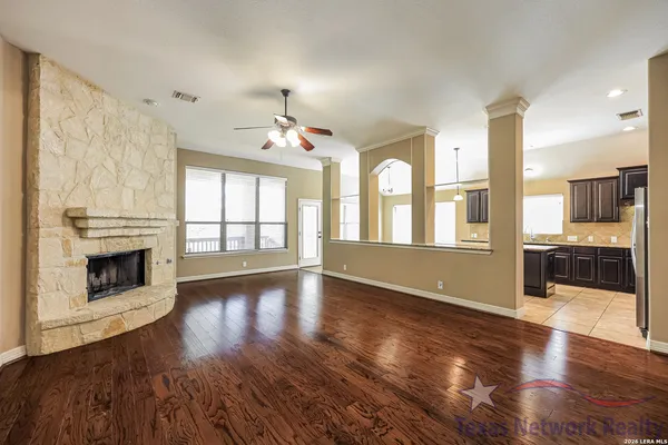 a view of a kitchen with a sink dishwasher and a fireplace