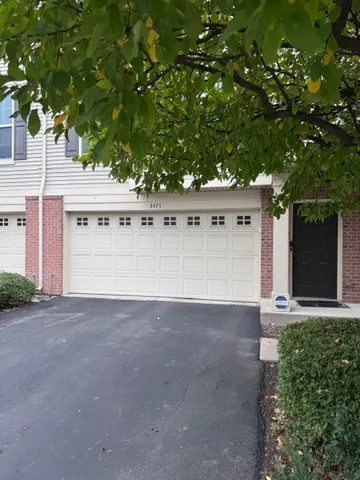 a view of a large white house with a large tree and a yard