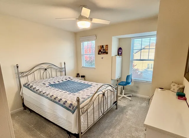 a bedroom with a bed next to a window