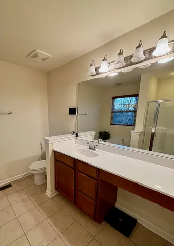 a spacious bathroom with a double vanity sink and a mirror