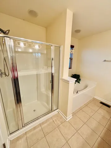 a bathroom with a glass shower door