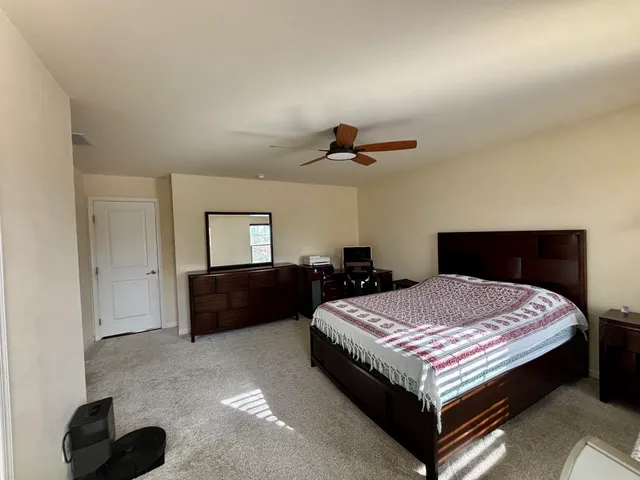 a bedroom with a bed and a dresser