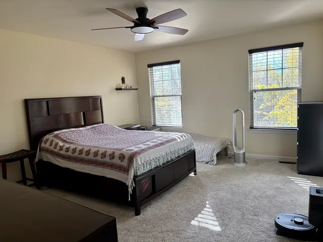 a bedroom with a bed and a window