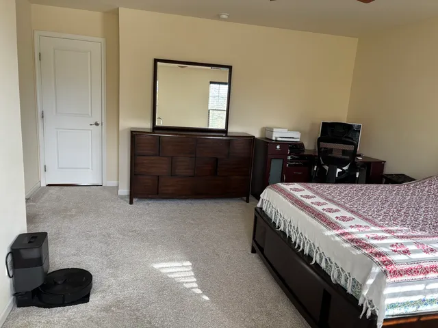 a bedroom with a bed and a dresser
