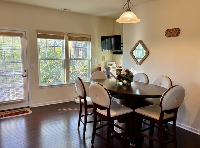a dining room with furniture and window
