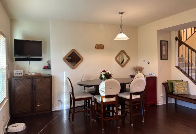 a view of a dining room with furniture and wooden floor