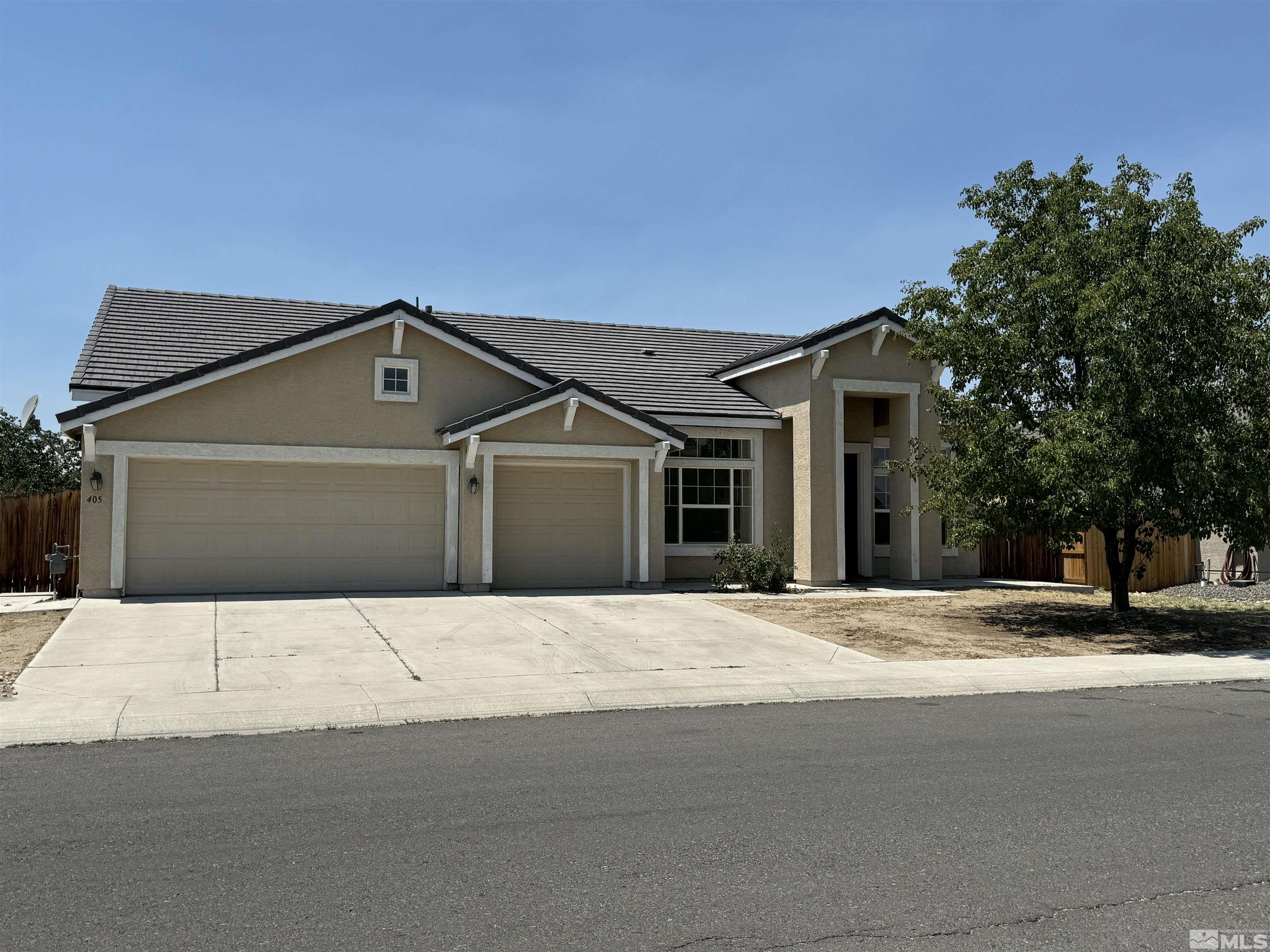 405 Sapphire Way Fallon, NV 89406 - Photo 1 of 30 a front view of a house with a yard and garage