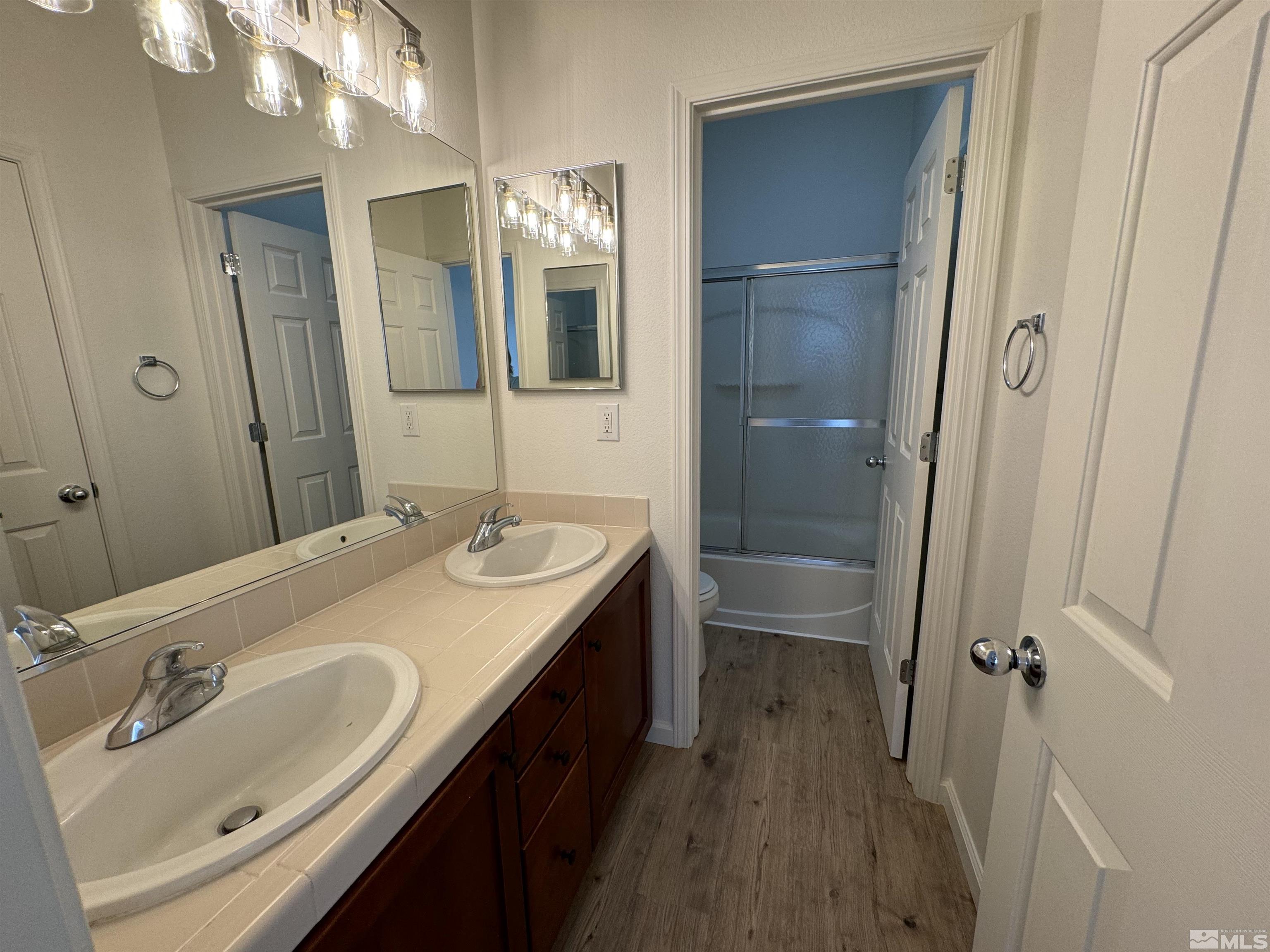 405 Sapphire Way Fallon, NV 89406 - Photo 16 of 30 a bathroom with a sink a vanity and a mirror