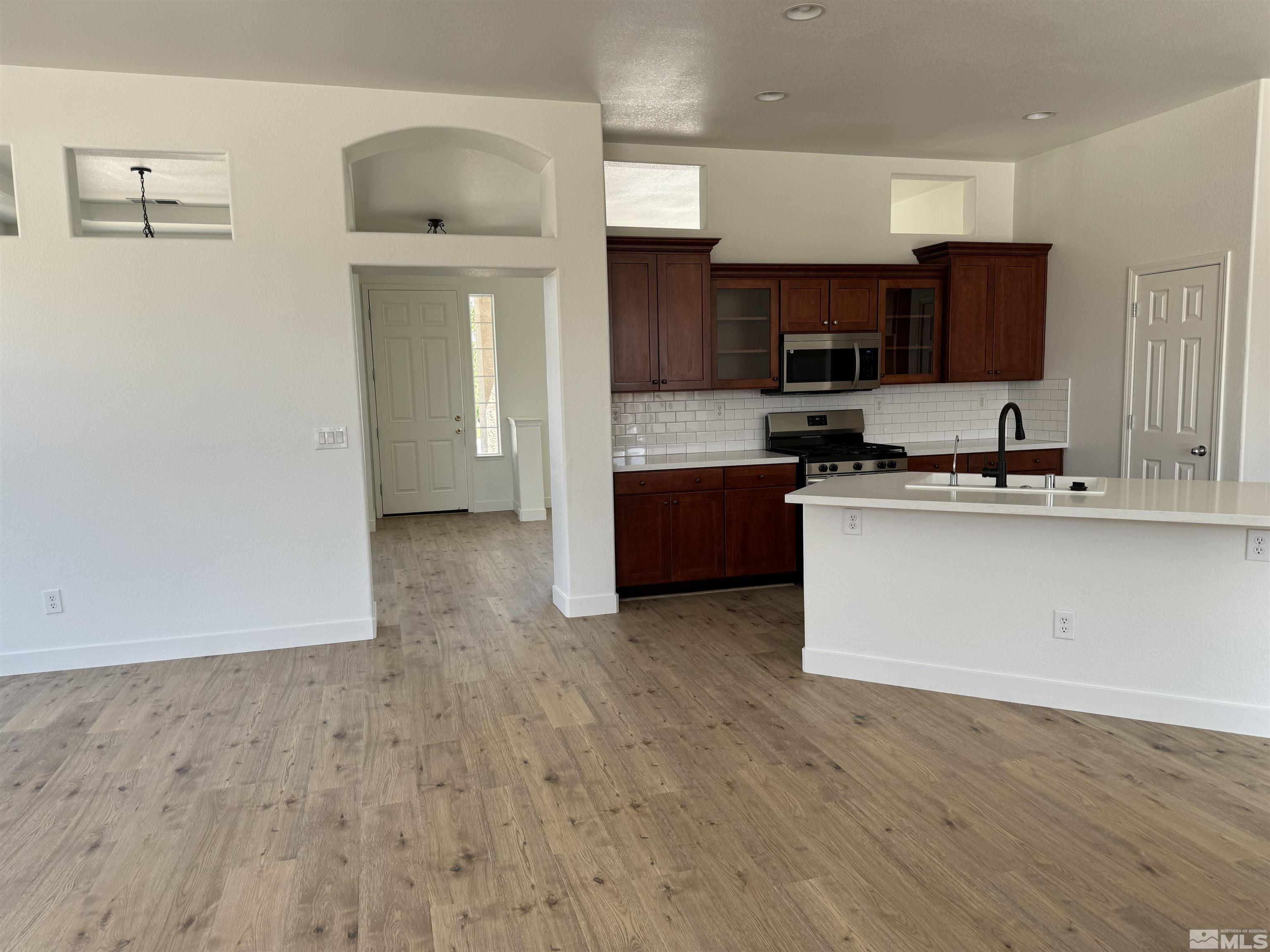 405 Sapphire Way Fallon, NV 89406 - Photo 2 of 30 a kitchen with stainless steel appliances granite countertop a sink stove and cabinets