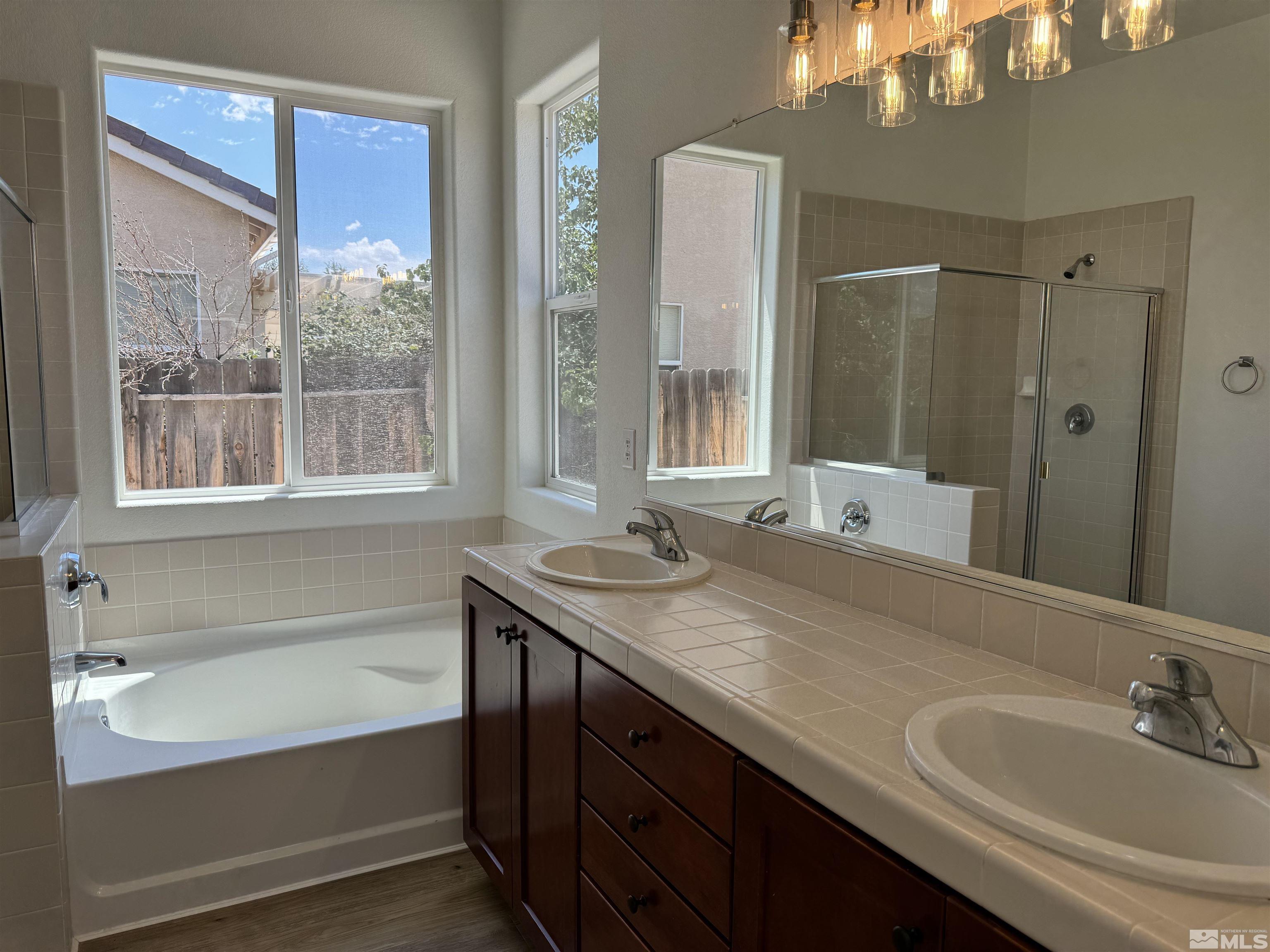 405 Sapphire Way Fallon, NV 89406 - Photo 22 of 30 a bathroom with a tub sink and a mirror