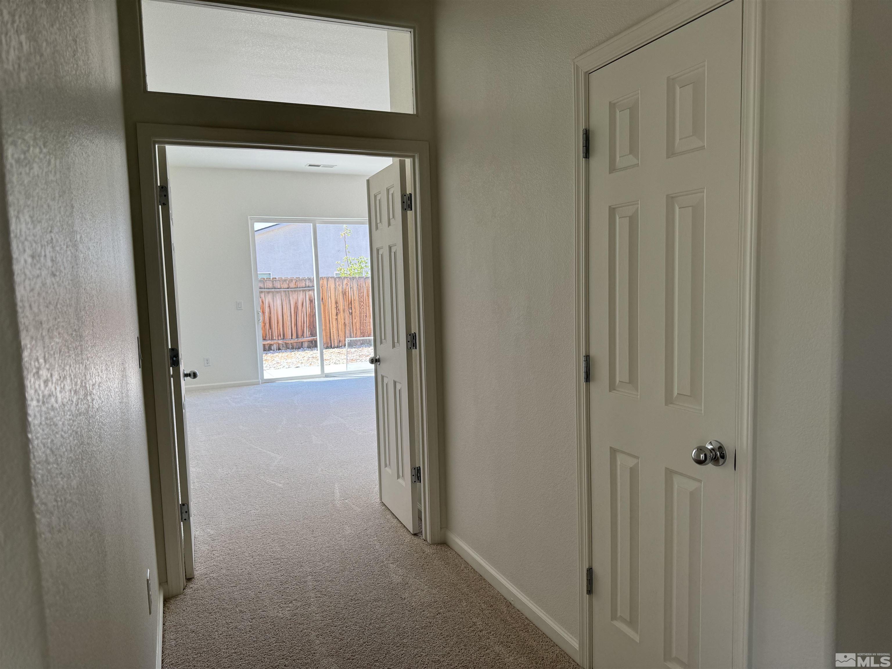 405 Sapphire Way Fallon, NV 89406 - Photo 23 of 30 a view of a hallway with a wooden door