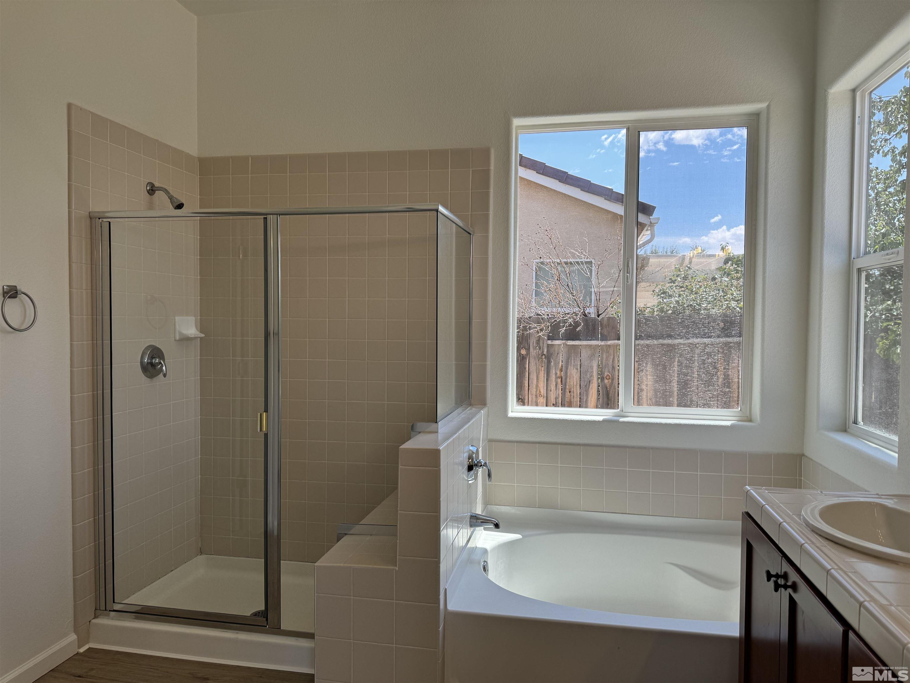 405 Sapphire Way Fallon, NV 89406 - Photo 25 of 30 a bathroom with a bathtub and a shower