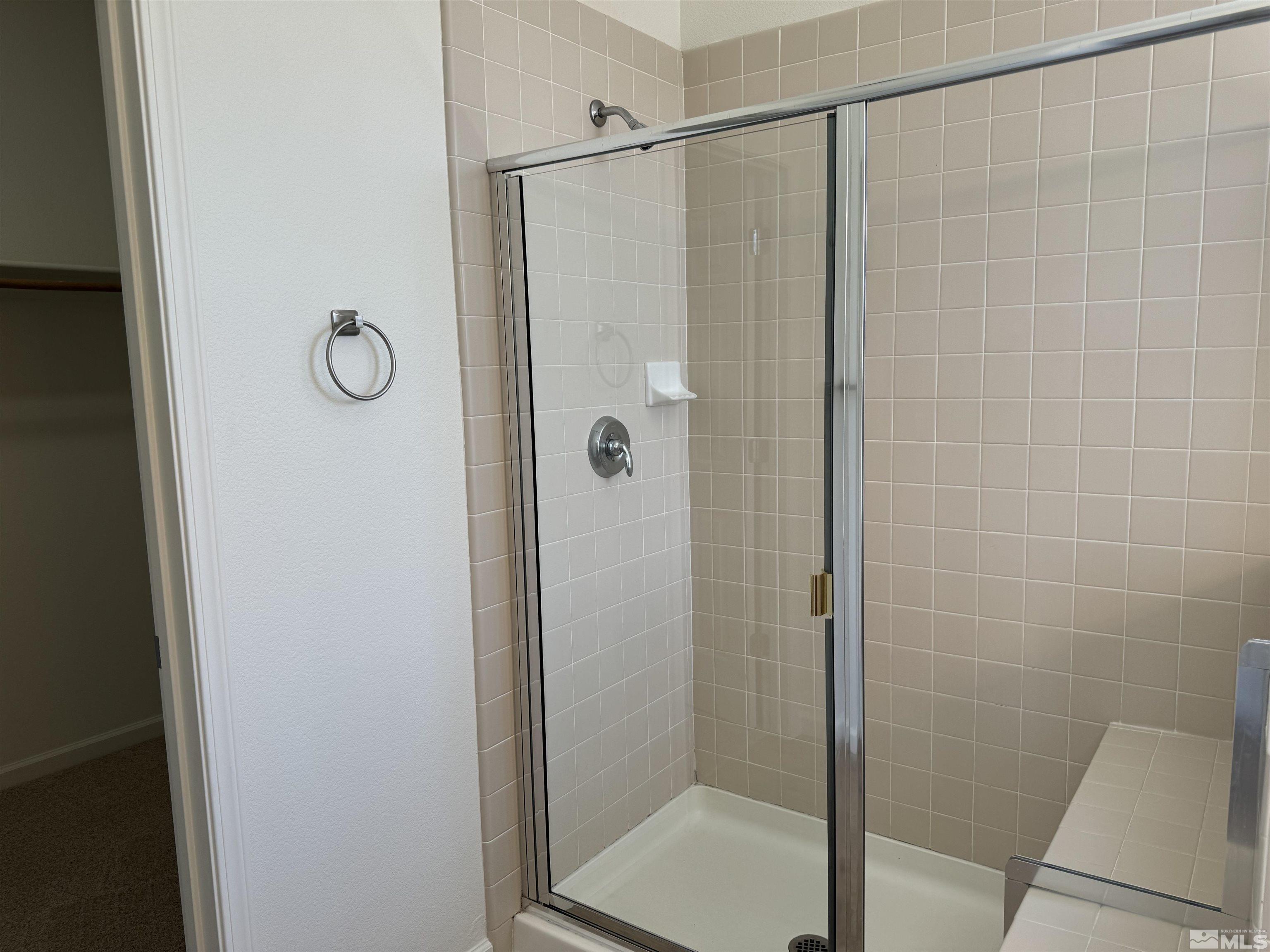 405 Sapphire Way Fallon, NV 89406 - Photo 29 of 30 a bathroom with a glass shower door