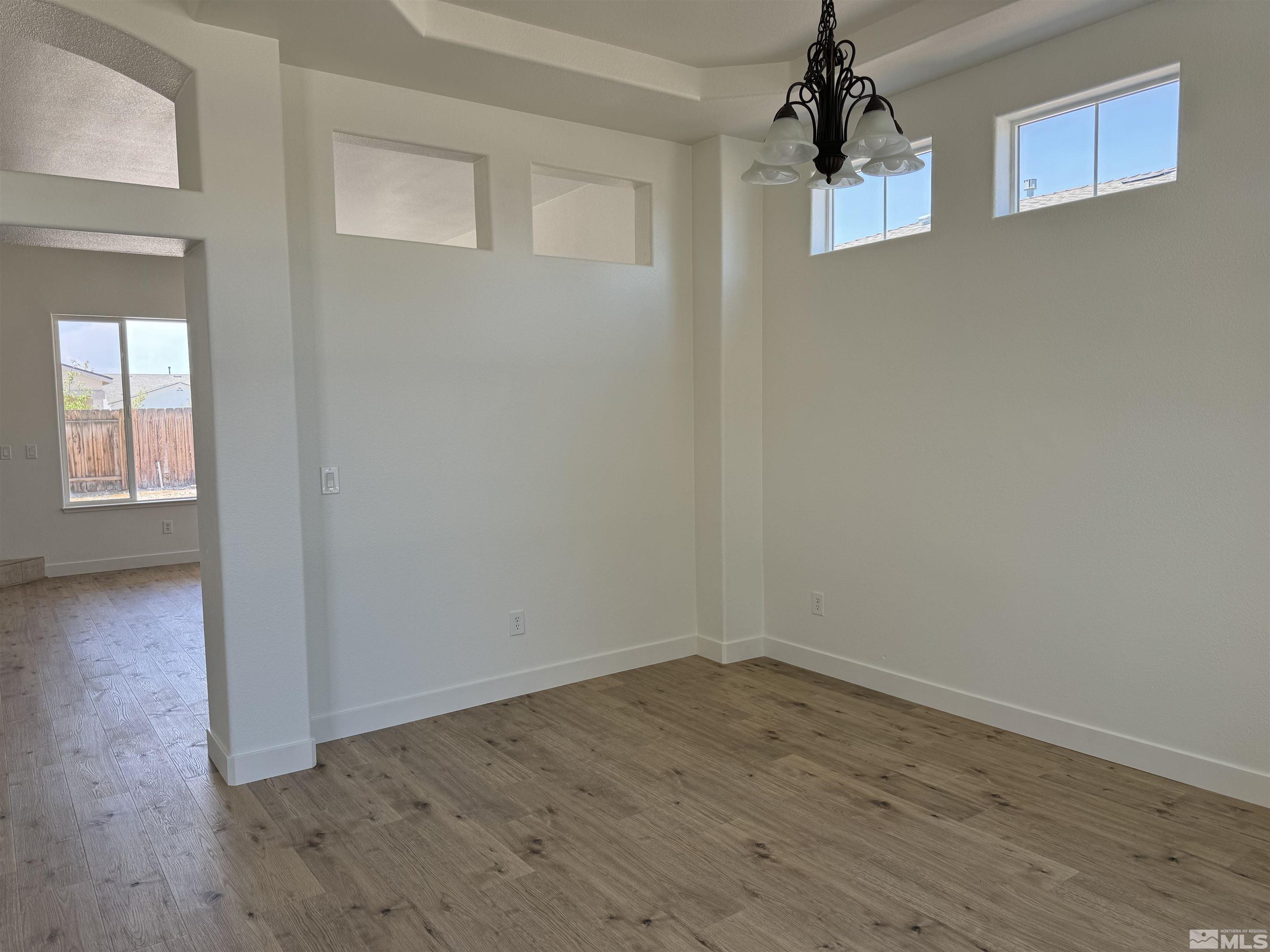 405 Sapphire Way Fallon, NV 89406 - Photo 3 of 30 a view of empty room with wooden floor and fan