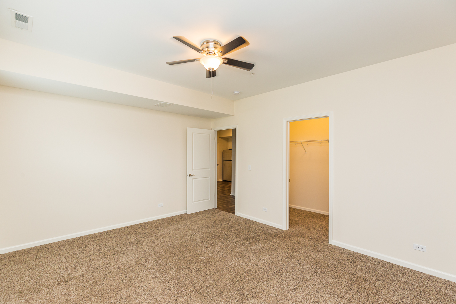 60 West Main Street, Unit 333 Lake Zurich, IL 60047 - Photo 8 of 15 a view of a livingroom with a ceiling fan and wooden floor