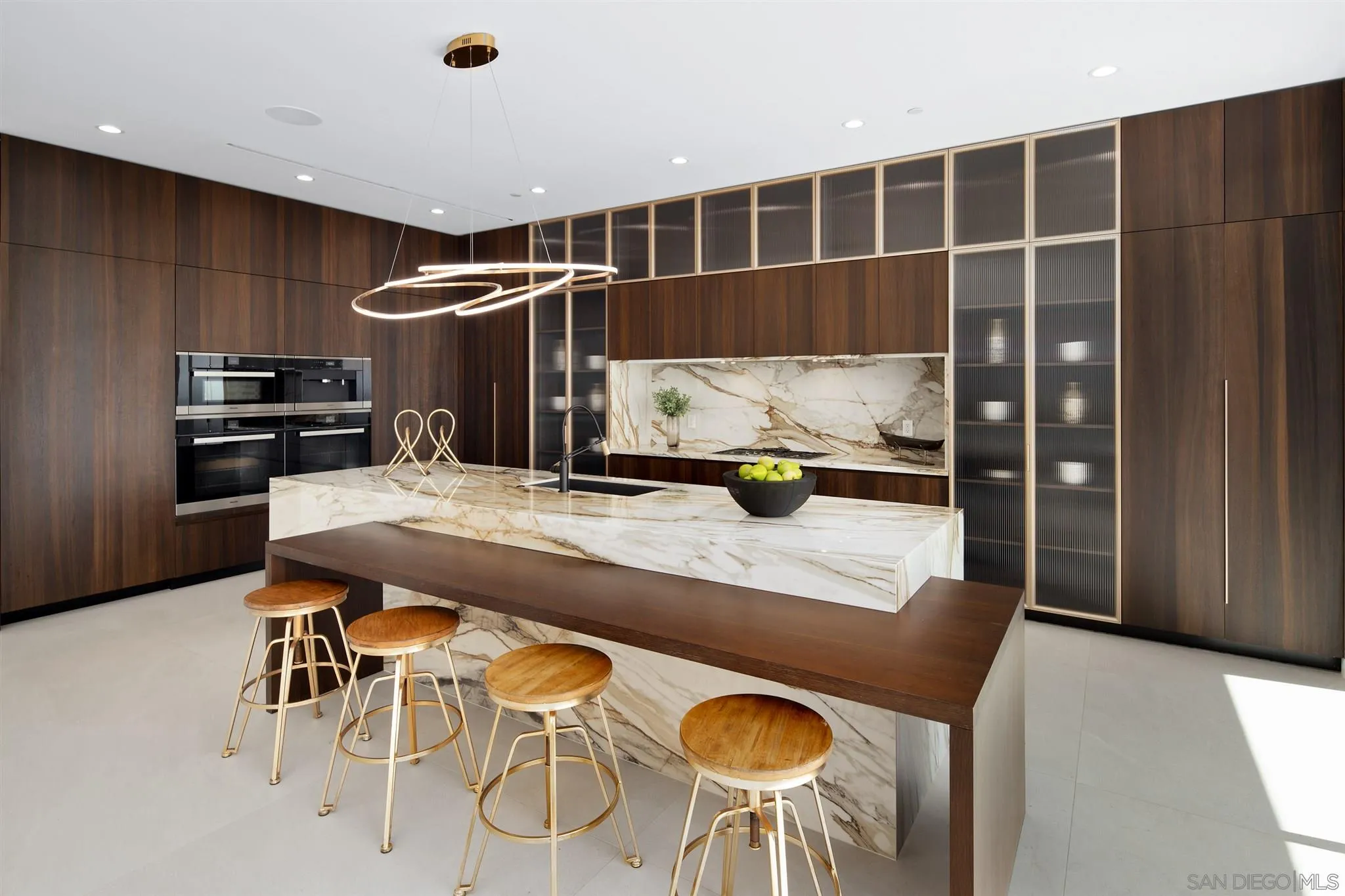 926 La Jolla Rancho Road La Jolla, CA 92037 - Photo 11 of 54 a kitchen with a table and chairs