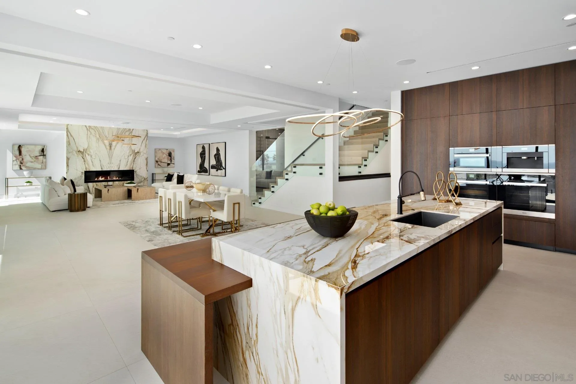 926 La Jolla Rancho Road La Jolla, CA 92037 - Photo 12 of 54 a kitchen with stainless steel appliances kitchen island granite countertop a sink dishwasher stove and refrigerator with wooden cabinets
