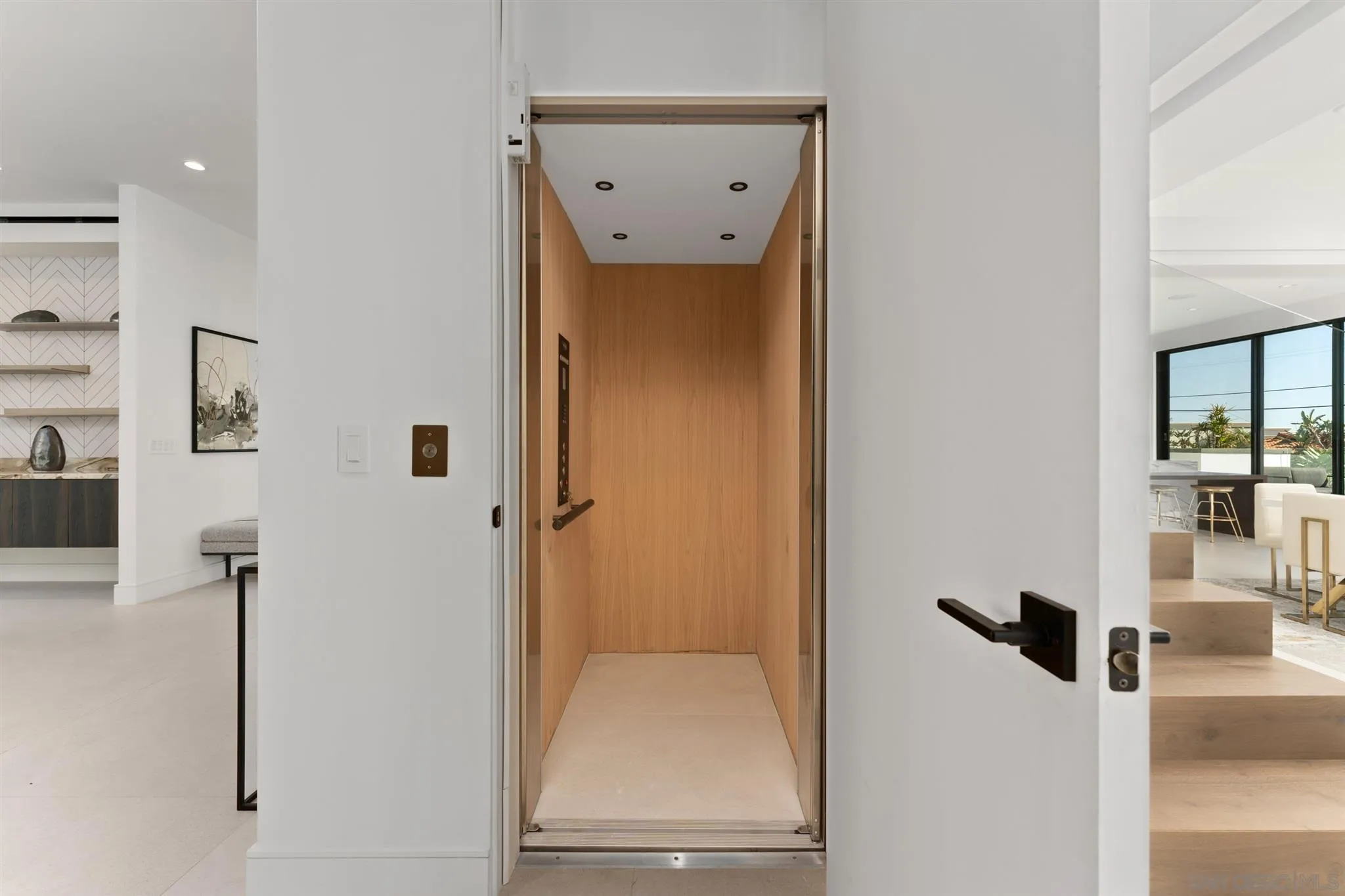 926 La Jolla Rancho Road La Jolla, CA 92037 - Photo 18 of 54 a view of a hallway with a door and couch