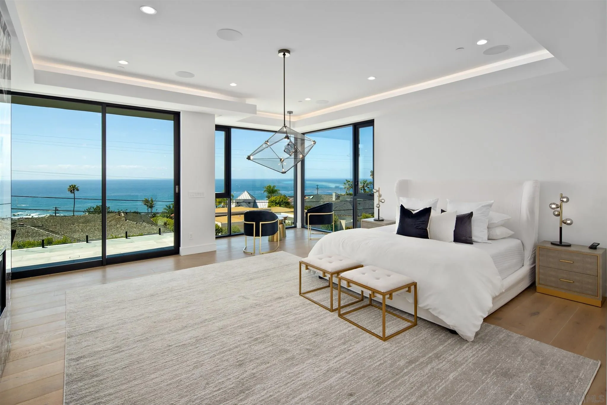 926 La Jolla Rancho Road La Jolla, CA 92037 - Photo 20 of 54 a spacious bedroom with a large bed and a chandelier