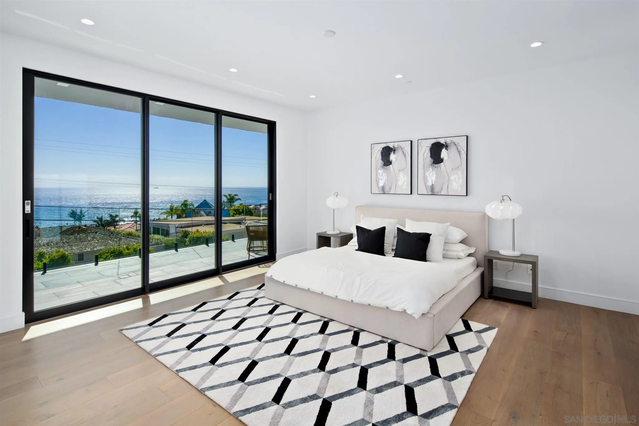 926 La Jolla Rancho Road La Jolla, CA 92037 - Photo 29 of 54 a living room with a large bed and a large window