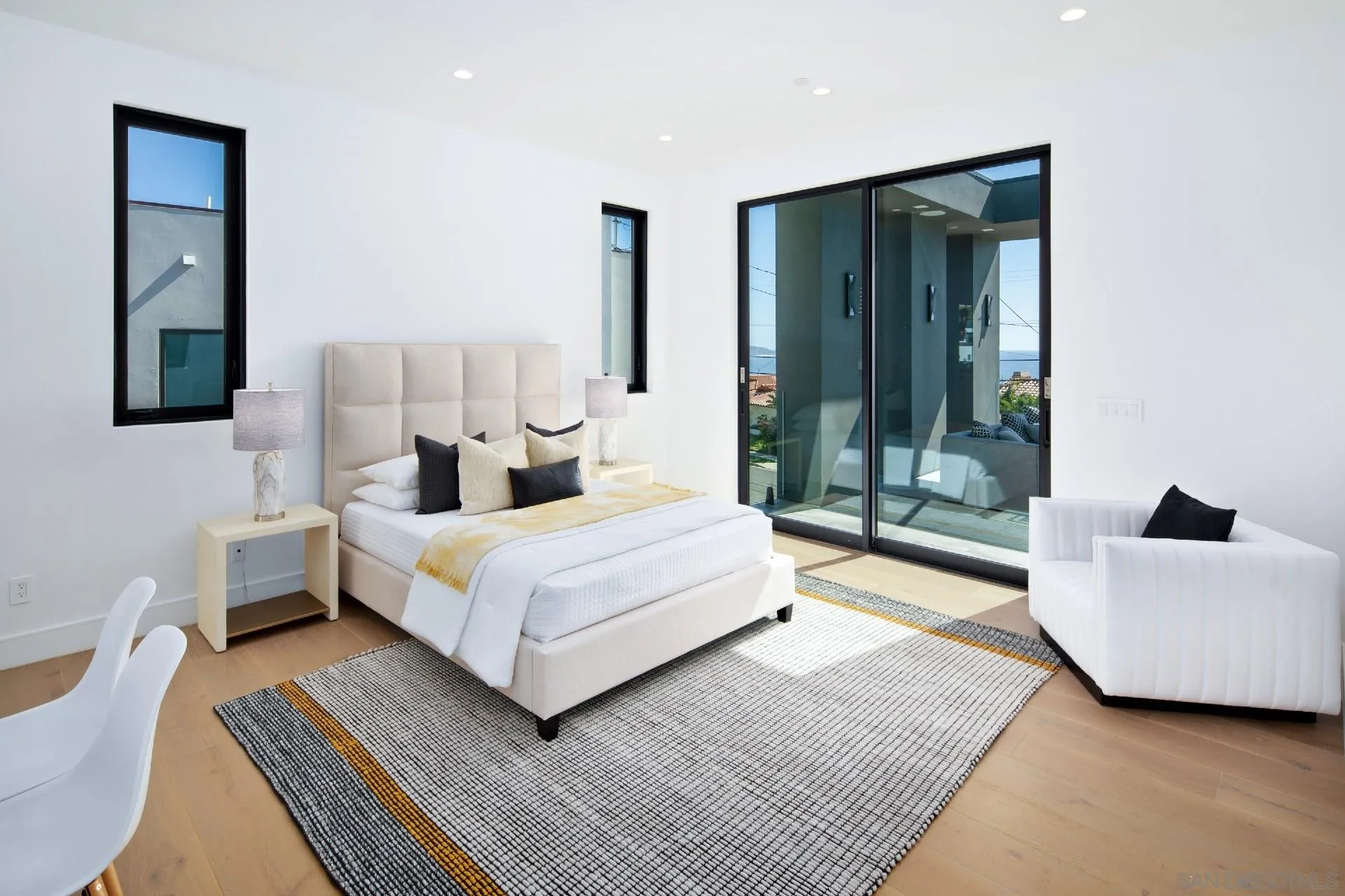 926 La Jolla Rancho Road La Jolla, CA 92037 - Photo 34 of 54 a bedroom with a large bed and a couch