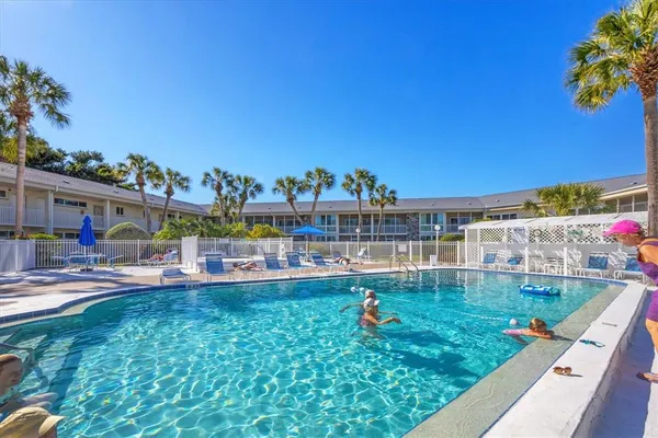 a view of a swimming pool with outdoor seating