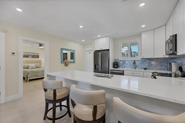 a kitchen with stainless steel appliances a refrigerator stove microwave and cabinets