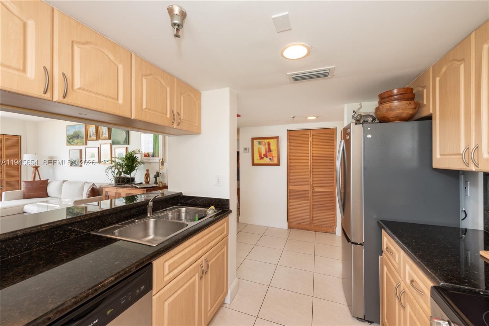 2400 Southwest 3rd Avenue, Unit 703 Miami, FL 33129 - Photo 13 of 29 a kitchen that has a sink and cabinets