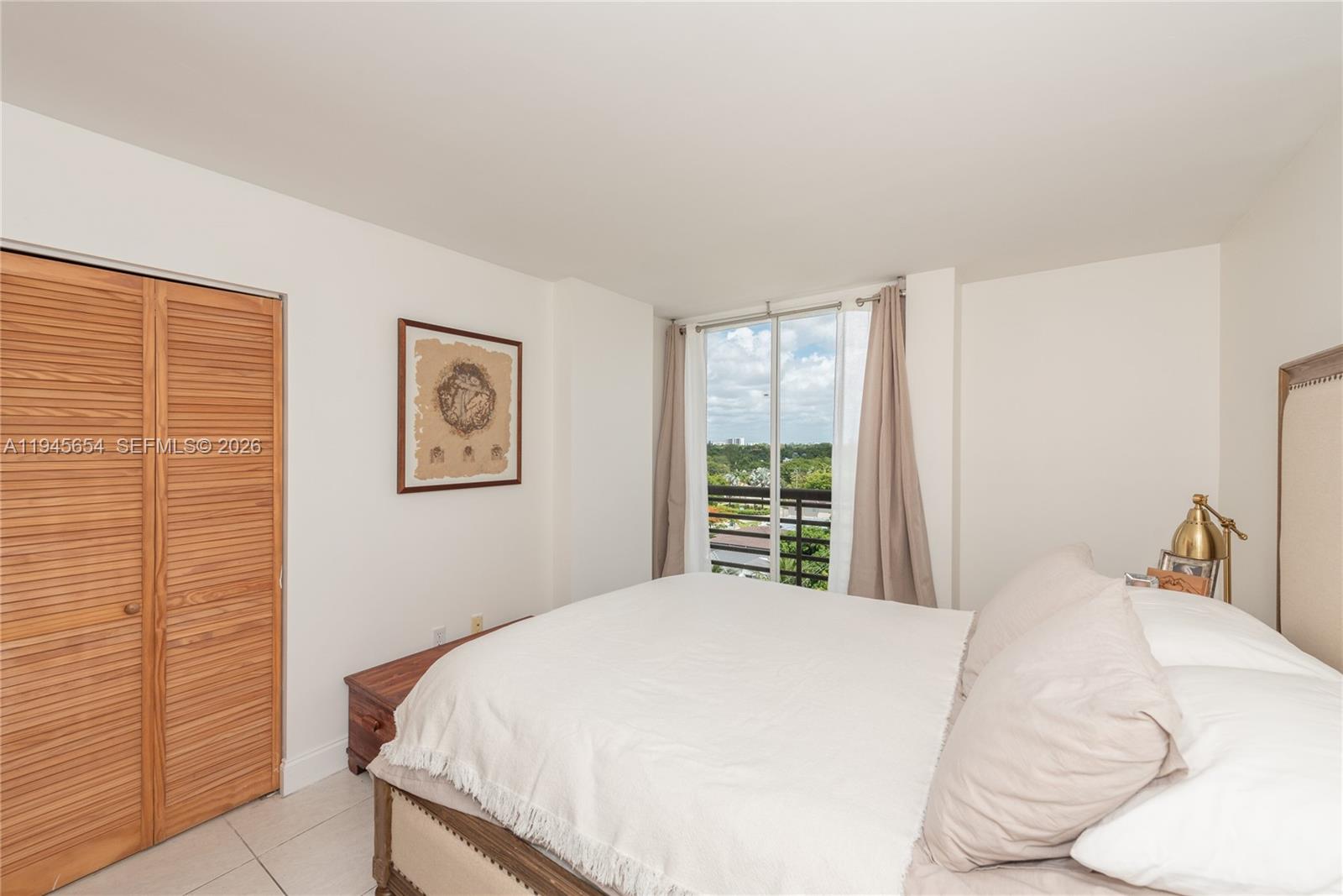 2400 Southwest 3rd Avenue, Unit 703 Miami, FL 33129 - Photo 20 of 29 a bedroom with a bed and a window