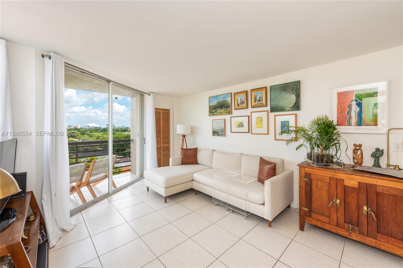 2400 Southwest 3rd Avenue, Unit 703 Miami, FL 33129 - Photo 4 of 29 a living room with furniture and a large window