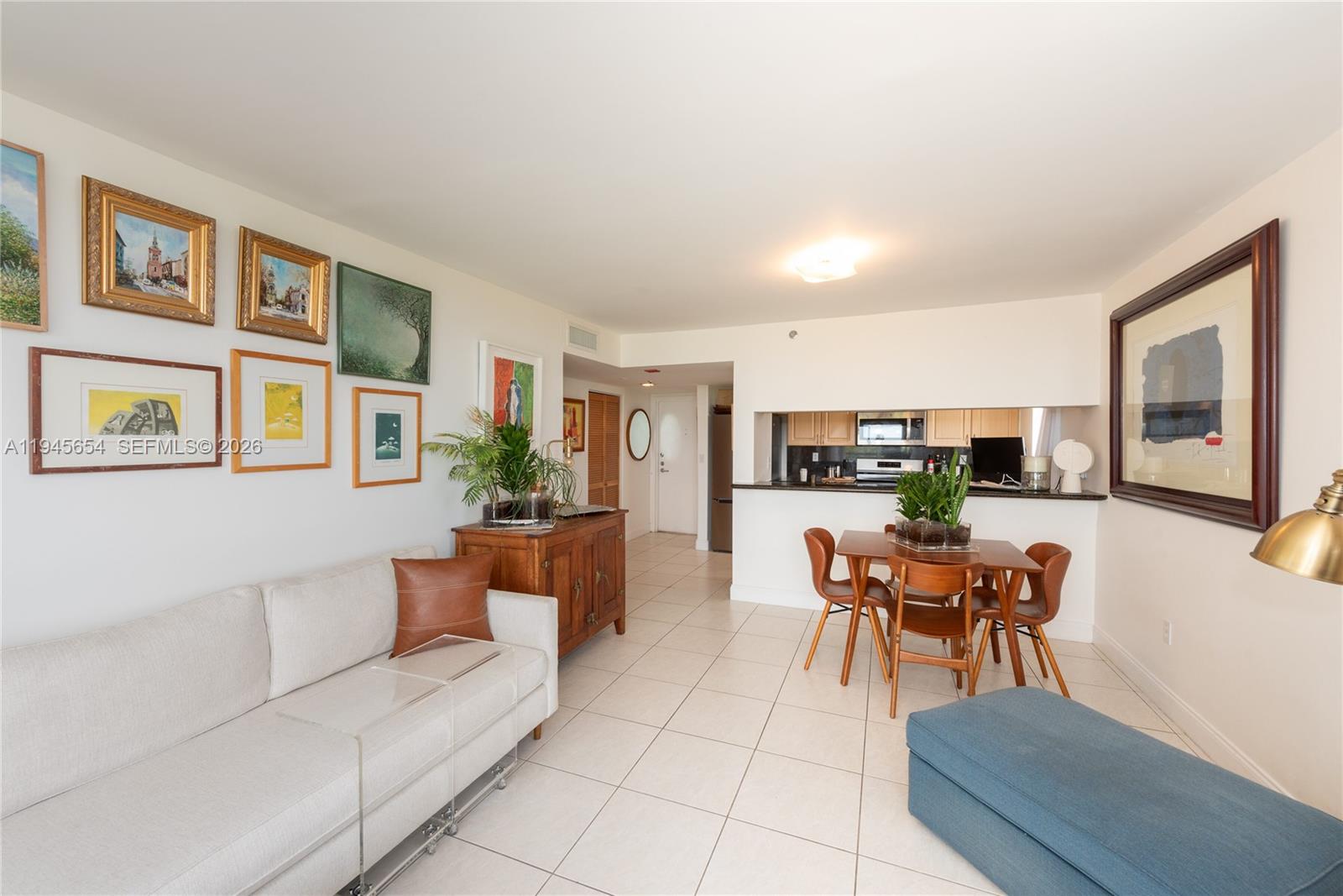 2400 Southwest 3rd Avenue, Unit 703 Miami, FL 33129 - Photo 9 of 29 a living room with furniture a table and kitchen view