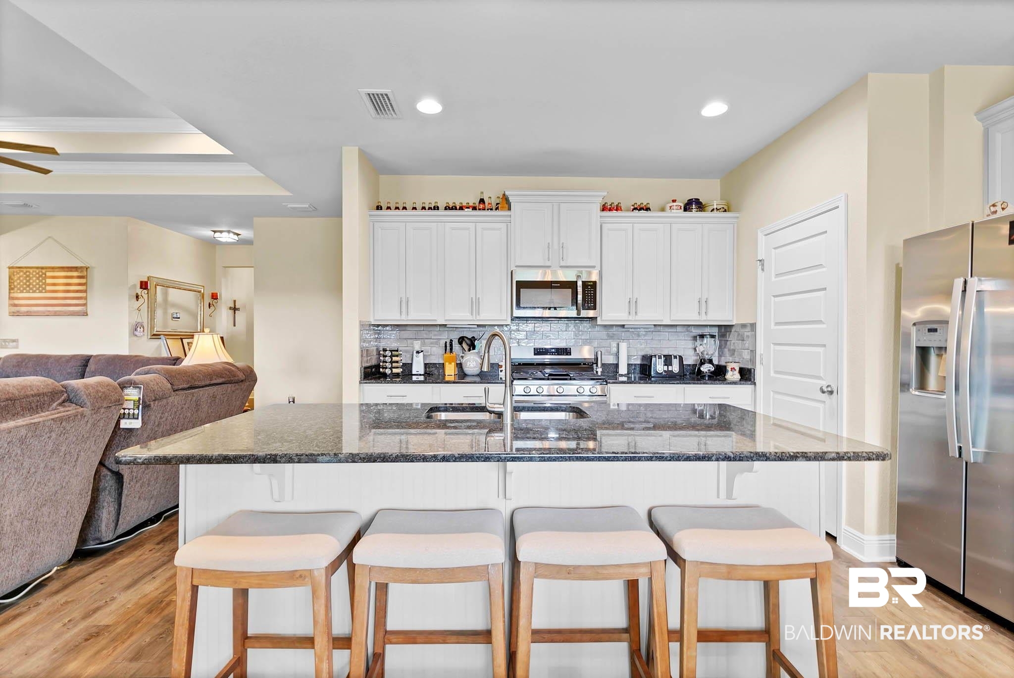 2049 Bourbon Street Foley, AL 36535 - Photo 54 of 56 Kitchen featuring appliances with stainless steel finishes, open floor plan, light wood-style flooring, decorative backsplash, and recessed lighting
