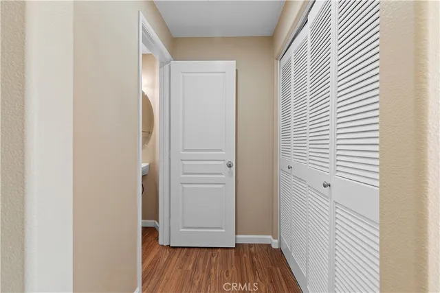 a view of a hallway with wooden floor