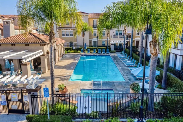 a view of multiple houses with a yard and potted plants