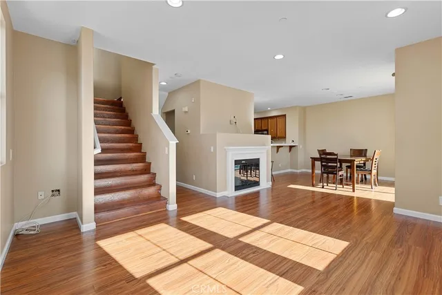 a living room with furniture a fireplace and wooden floor