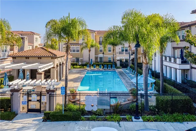 a aerial view of a residential apartment building with a yard and potted plants